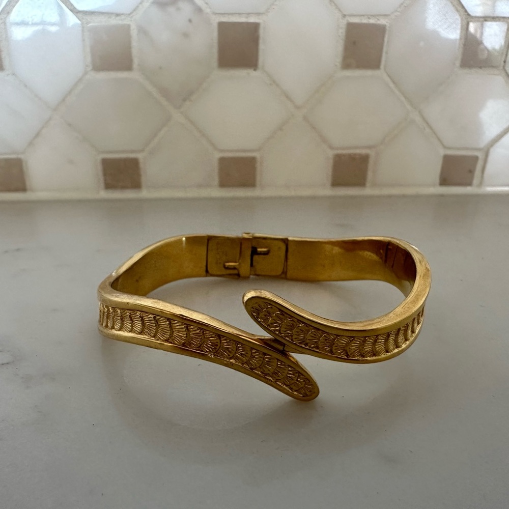 Vintage Monet Shell pattern gold tone clamper bracelet.